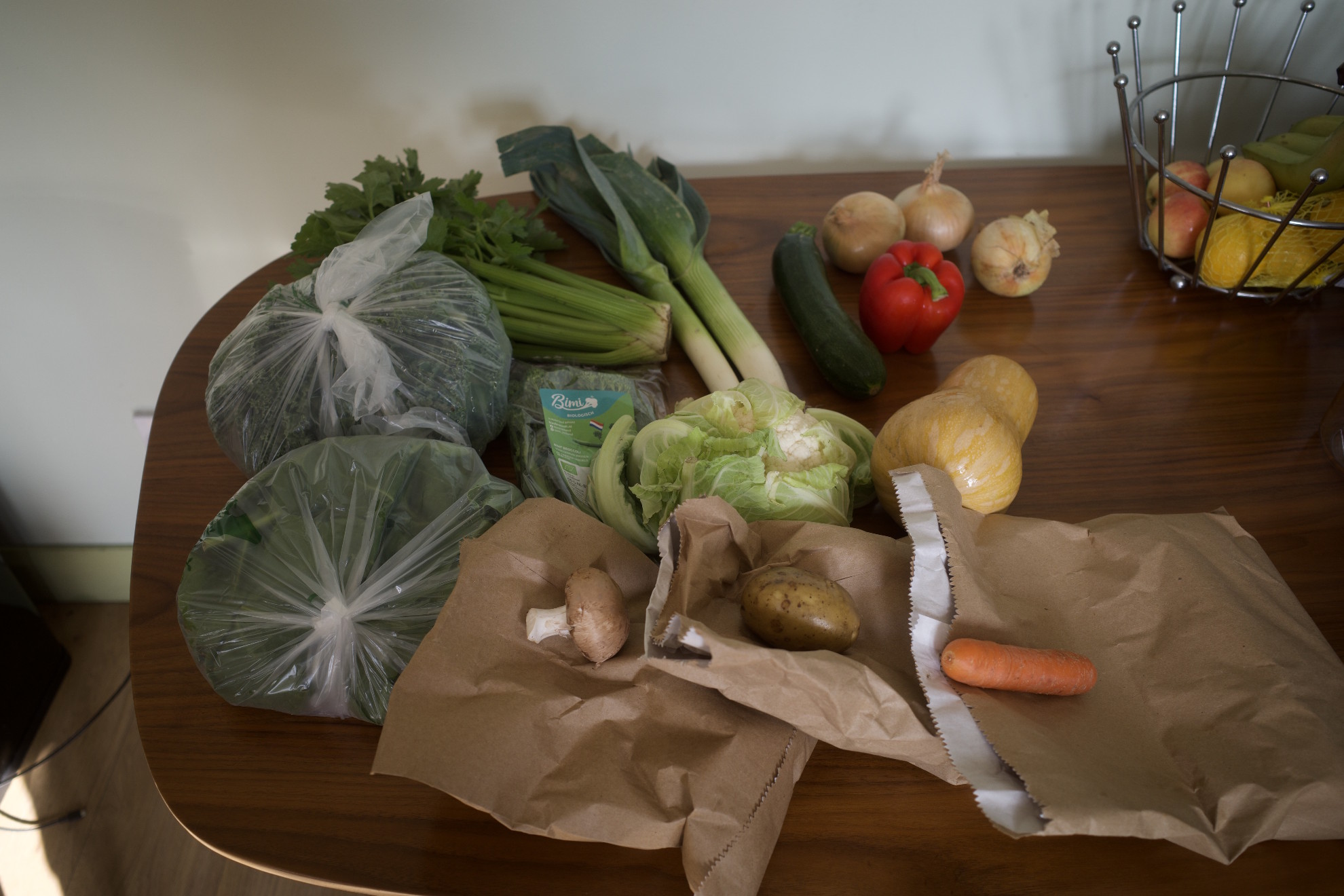 A variety of vegetables on a wooden kitchen table