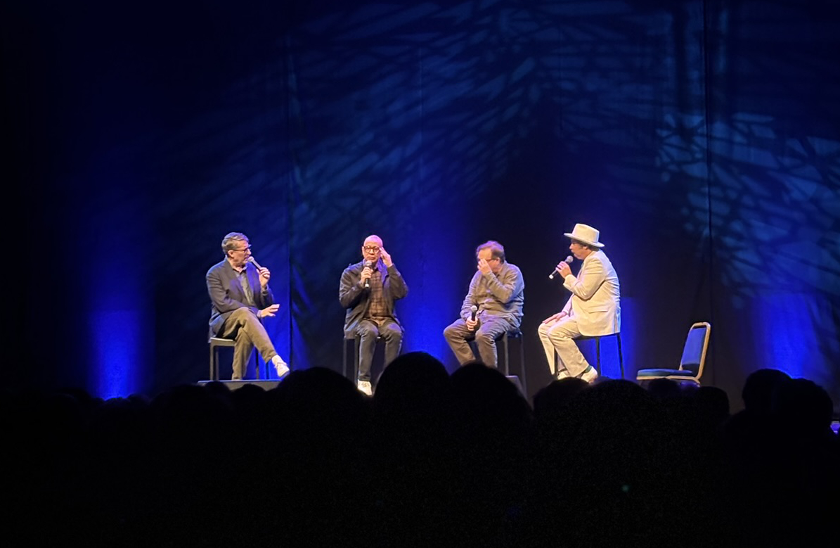 Scott Aukerman, Paul F. Tompkins, Andy Daly & Fred Armisen on stage in Vicar street with a crowd in front of them.
